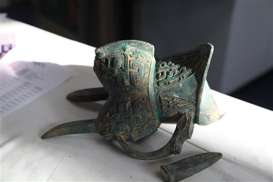 A Chinese archaistic bronze jue vessel and cover, 29cm, damage